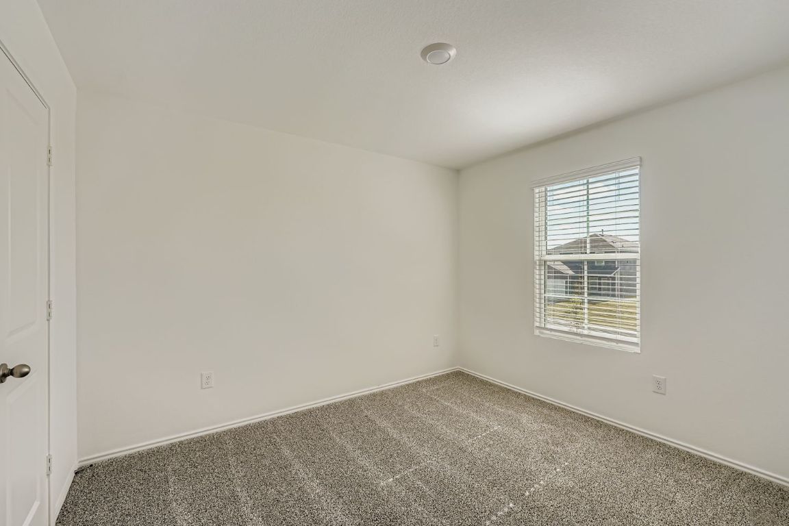 12112 Douglas Fir Circle Mustang Ridge, TX 78610 - Photo 23 of 33 an empty room with windows