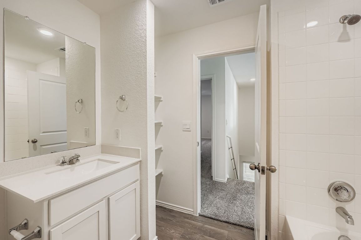 12112 Douglas Fir Circle Mustang Ridge, TX 78610 - Photo 28 of 33 a bathroom with a sink and a mirror