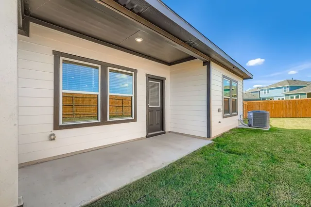 a front view of a house with wooden fence