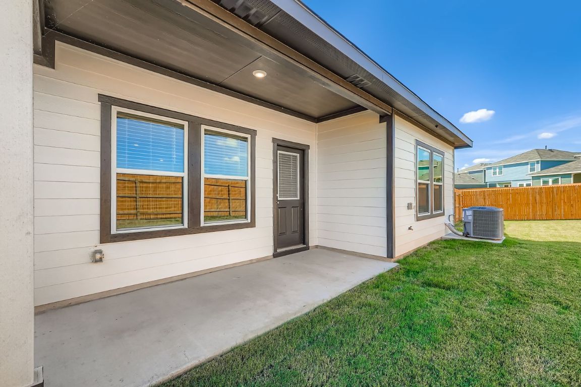 12112 Douglas Fir Circle Mustang Ridge, TX 78610 - Photo 32 of 33 a view of an house with backyard