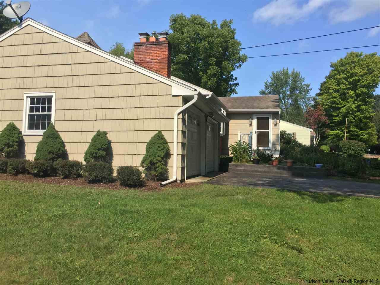 222 Rickey Road Stone Ridge, NY 12484 - Photo 14 of 16 a view of a white house next to a yard and palm trees