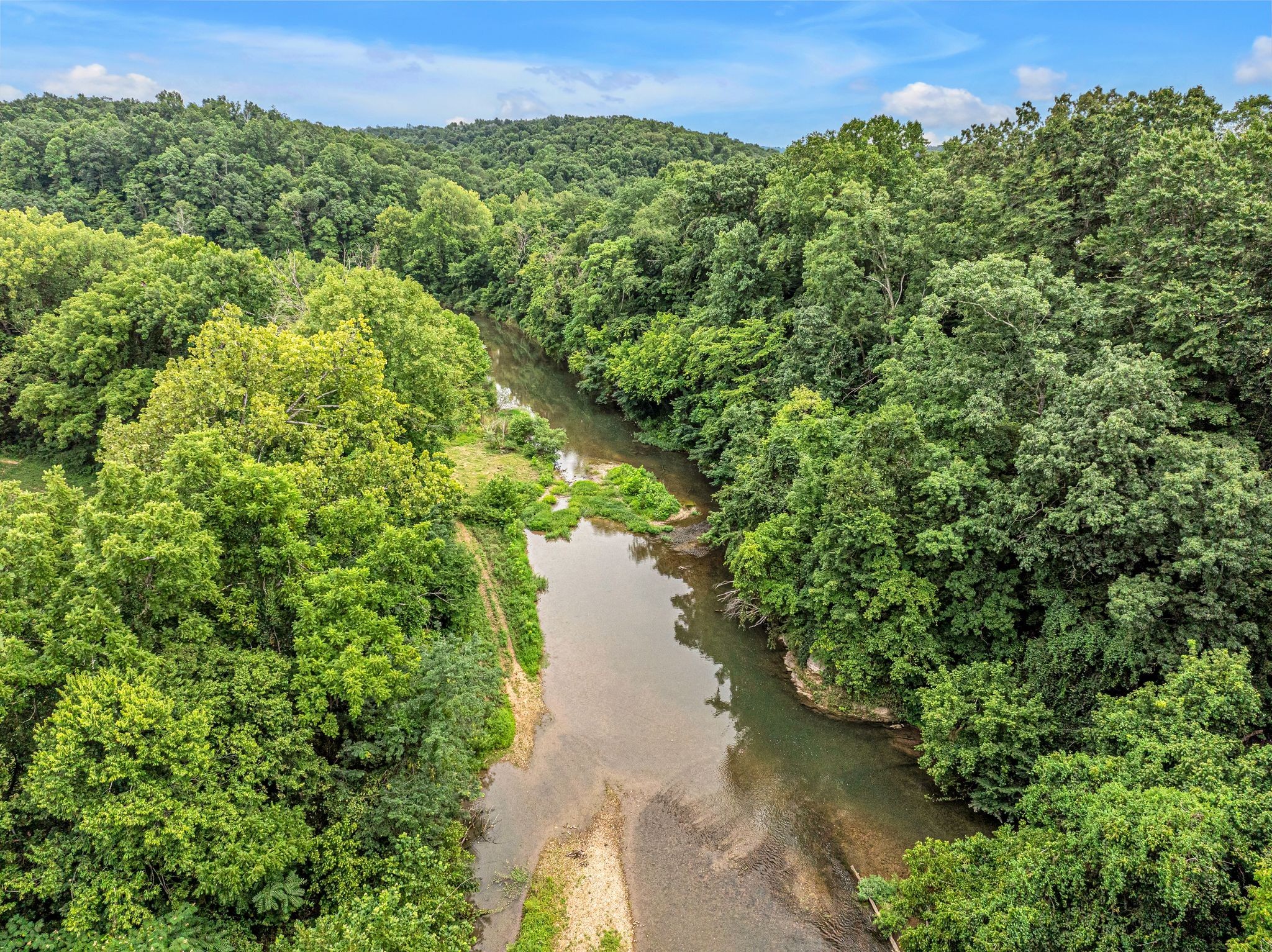 1259 Petty Road White Bluff, TN 37187 - Photo 29 of 60 a view of a lake with a building in the background