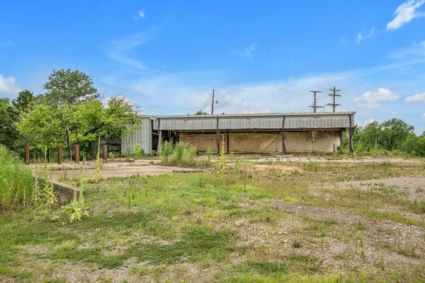a view of a house with a yard and a garage
