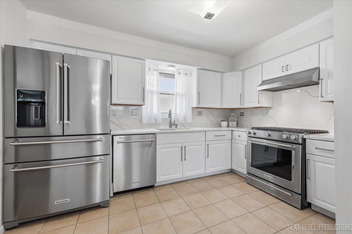 754 North Michigan Street Elmhurst, IL 60126 - Photo 12 of 32 a kitchen with stainless steel appliances granite countertop a stove a sink and a refrigerator