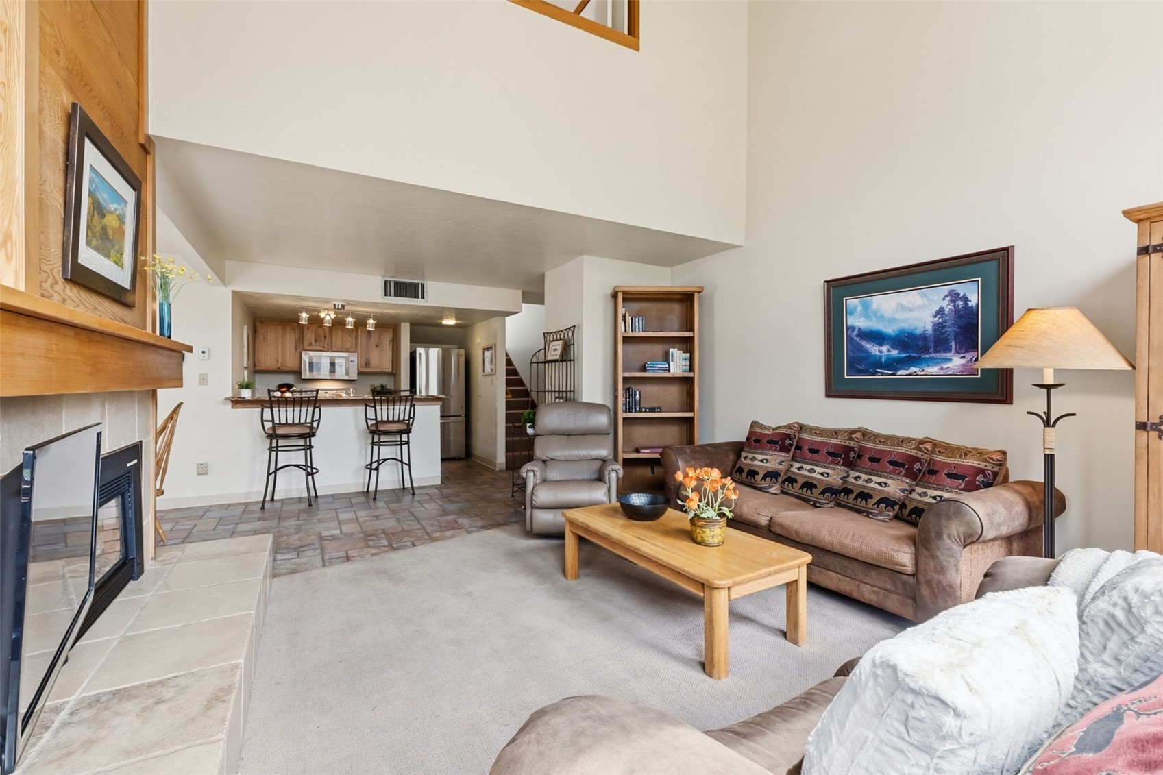 30 Tennis Club Road, Unit 1608 Keystone, CO 80435 - Photo 4 of 29 a living room with furniture kitchen view and a fireplace