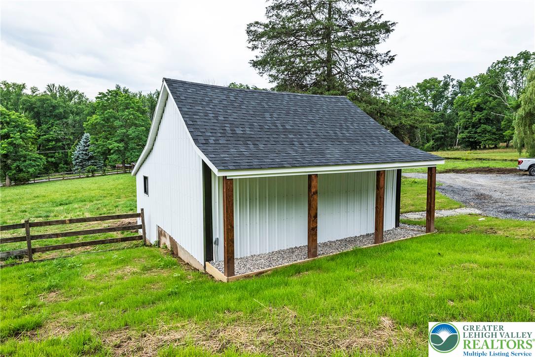 72 Allegheny Road Mount Bethel, PA 18343 - Photo 50 of 72 A new construction outbuilding with a protective overhang sits on a well-maintained grassy expanse.