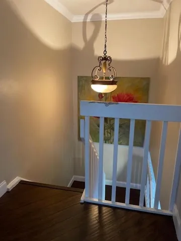 a view of staircase with railing and wooden floor