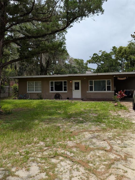 a front view of house with yard and green space