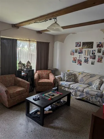 a bedroom with furniture and a large window