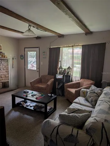 a living room with furniture gym equipment and a window