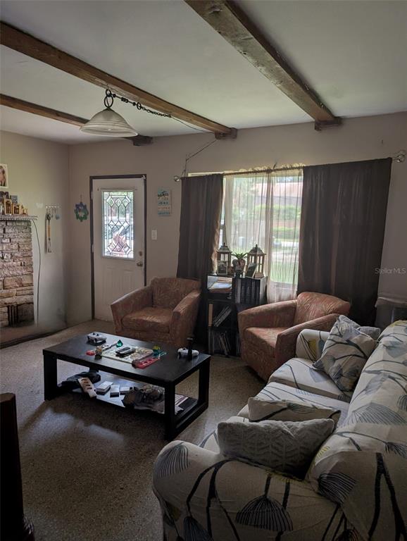 5610 Wilson Road Sanford, FL 32771 - Photo 3 of 10 a living room with furniture gym equipment and a window