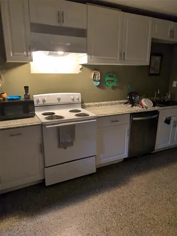 a kitchen with stainless steel appliances granite countertop a sink and a stove