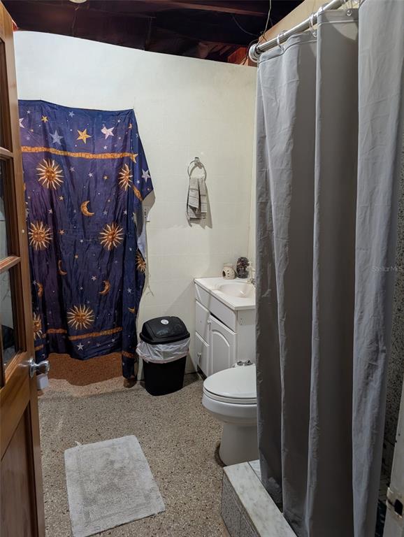 5610 Wilson Road Sanford, FL 32771 - Photo 7 of 10 a bathroom with a toilet and a shower curtain