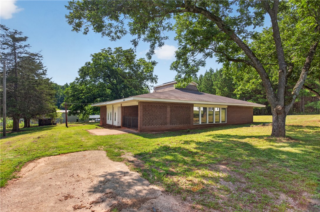 1412 Simpson Road Pendleton, SC 29670 - Photo 46 of 48 A classic brick residence nestled within a verdant, sprawling landscape.