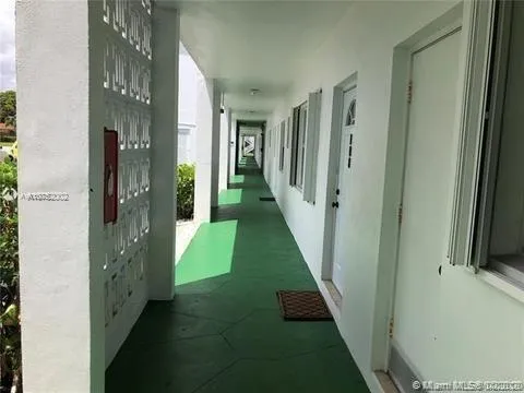 a view of a hallway with windows