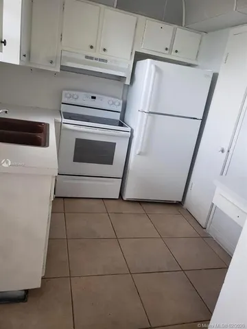 a white refrigerator freezer sitting inside of a kitchen