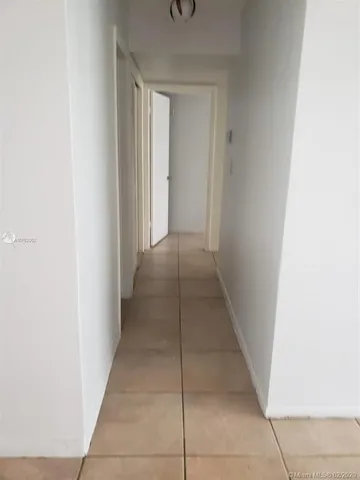 a view of a hallway to rooms