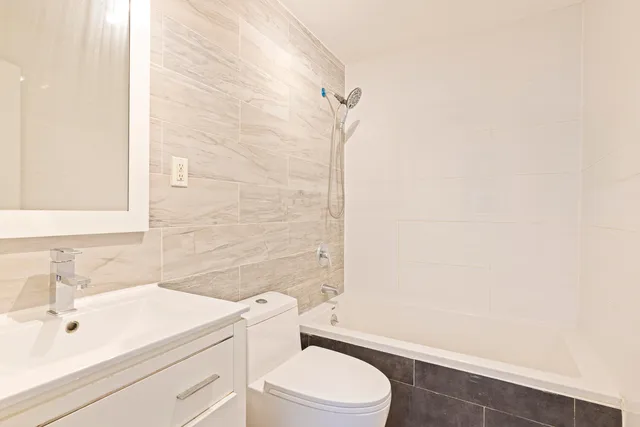 a bathroom with a toilet a sink and a mirror