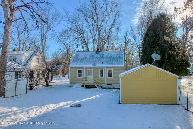 a view of a house with a large tree
