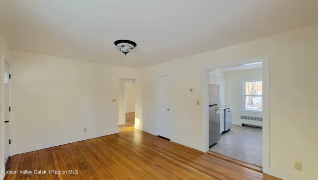 a view of a room with wooden floor and bathroom