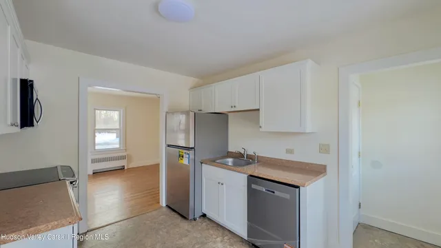a kitchen with a refrigerator sink and cabinets