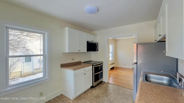 a kitchen that has a sink and a stove in it