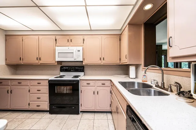a kitchen with a sink stove and cabinets