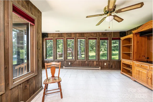 a view of a hallway with furniture and a window