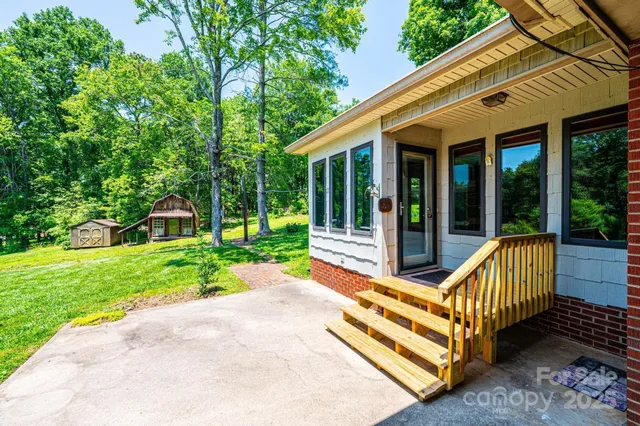 a front view of a house with a yard and green space