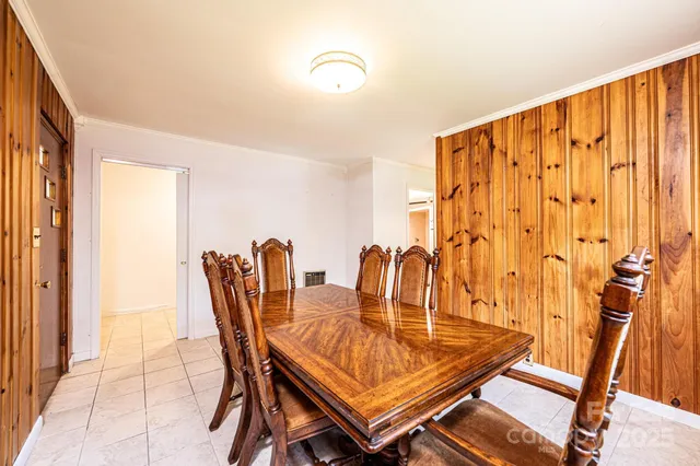a dining room with furniture and a rug