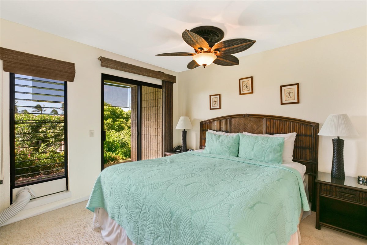 1870 Hoone Road, Unit 802 Koloa, HI 96756 - Photo 16 of 24 a bedroom with a large bed and a large window