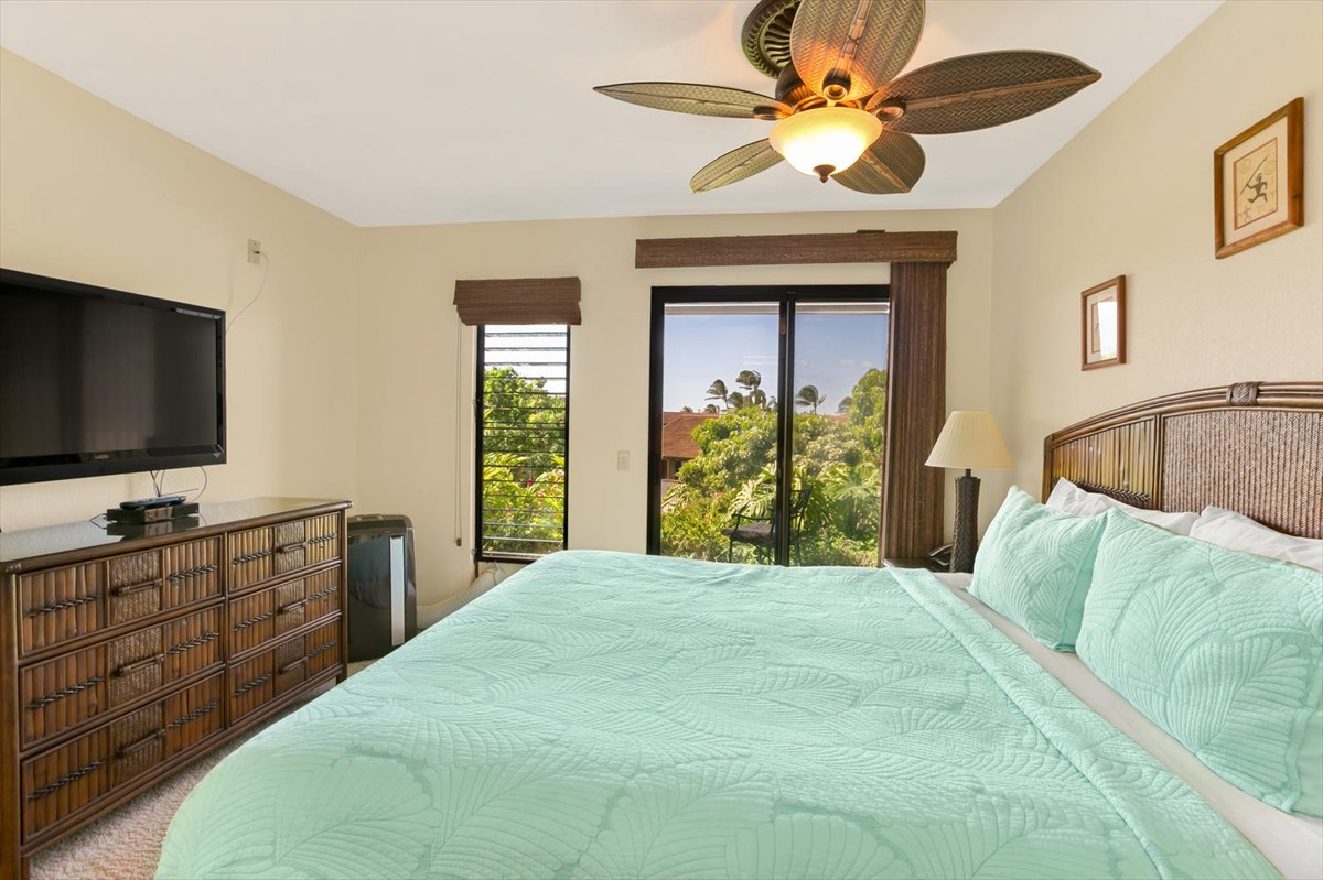 1870 Hoone Road, Unit 802 Koloa, HI 96756 - Photo 17 of 24 a bedroom with a bed and a flat screen tv