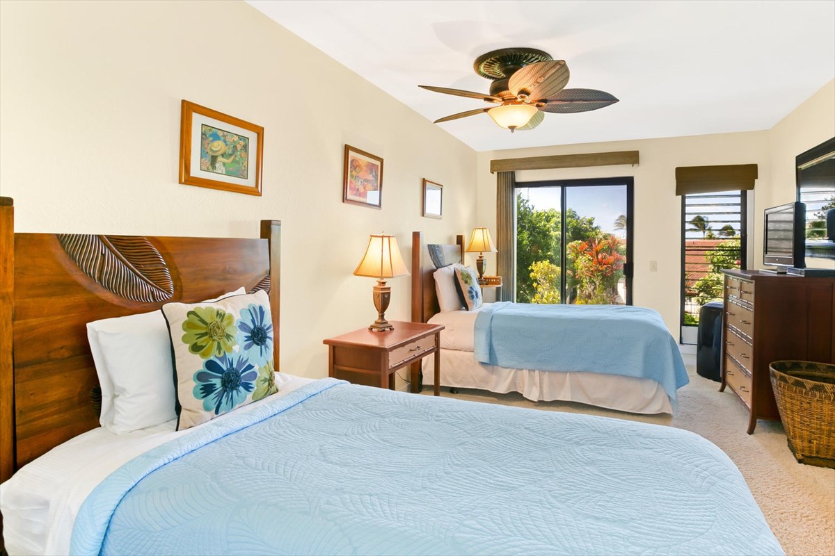 1870 Hoone Road, Unit 802 Koloa, HI 96756 - Photo 19 of 24 a bedroom with a bed and a chandelier