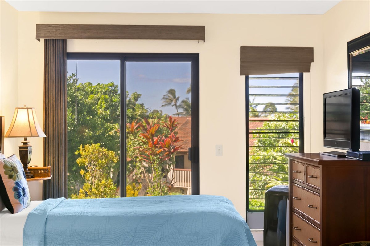 1870 Hoone Road, Unit 802 Koloa, HI 96756 - Photo 20 of 24 a bedroom with a bed and a flat tv screen on dresser