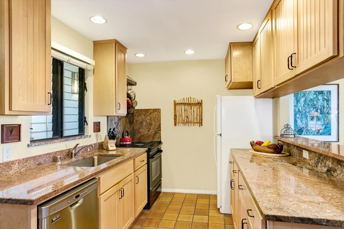 1870 Hoone Road, Unit 802 Koloa, HI 96756 - Photo 2 of 24 a kitchen with stainless steel appliances granite countertop a sink stove and cabinets