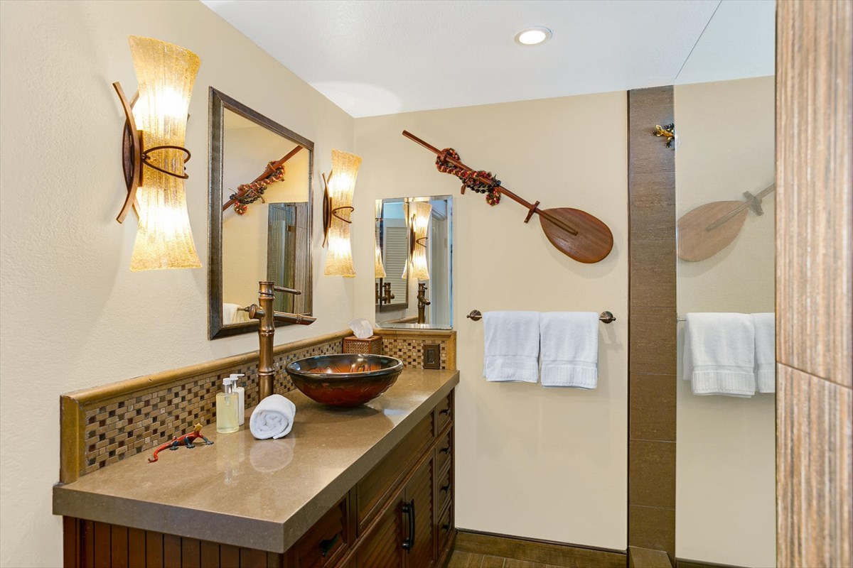 1870 Hoone Road, Unit 802 Koloa, HI 96756 - Photo 5 of 24 a bathroom with a sink mirror and vanity