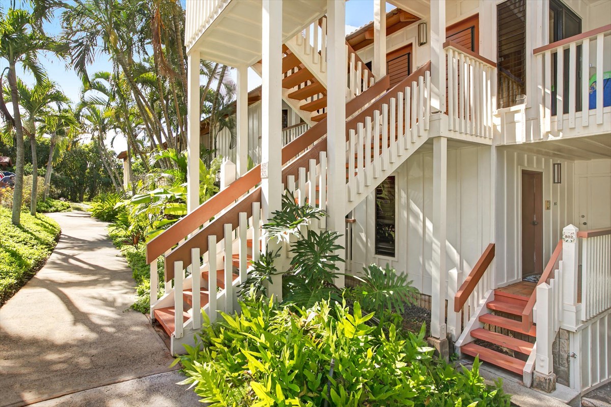 1870 Hoone Road, Unit 802 Koloa, HI 96756 - Photo 6 of 24 a view of an buildings with wooden stairs and potted plants