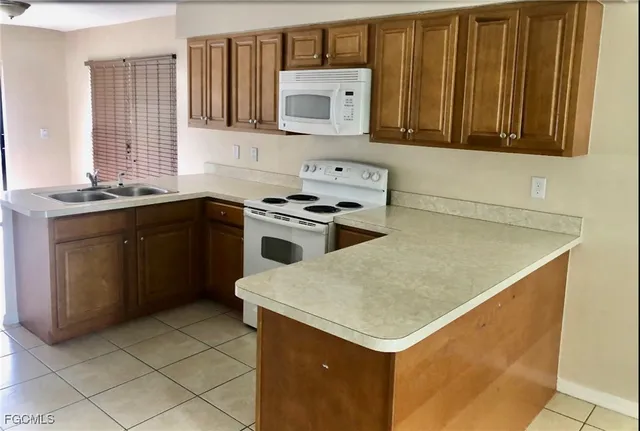 a kitchen with a stove sink and cabinets