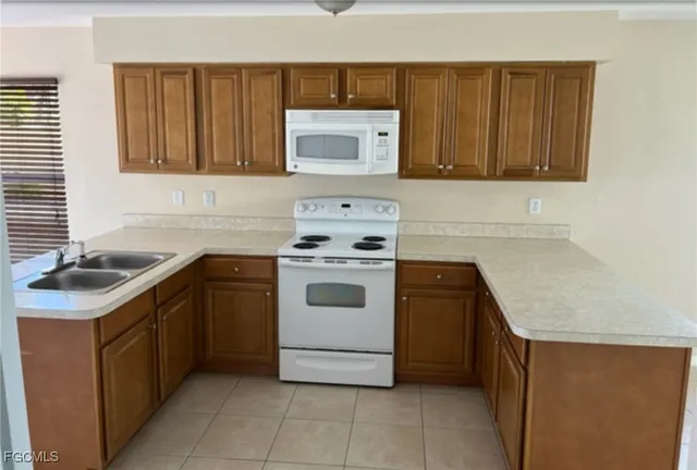 a living room with stainless steel appliances kitchen island granite countertop a refrigerator a stove and a sink