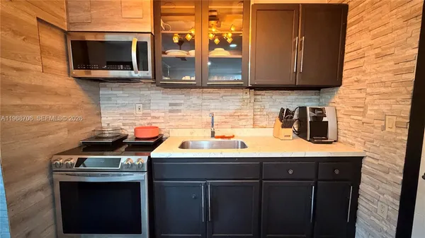 a kitchen with stainless steel appliances a stove and a microwave