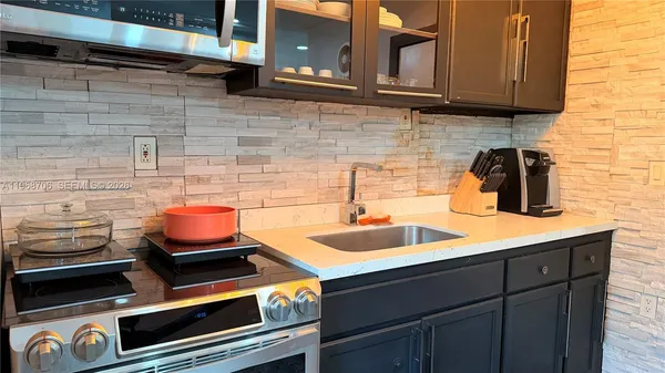 a kitchen with a sink and cabinets