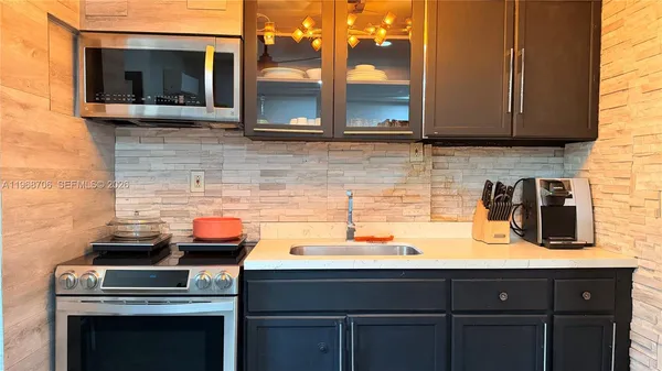 a kitchen with a sink and a microwave