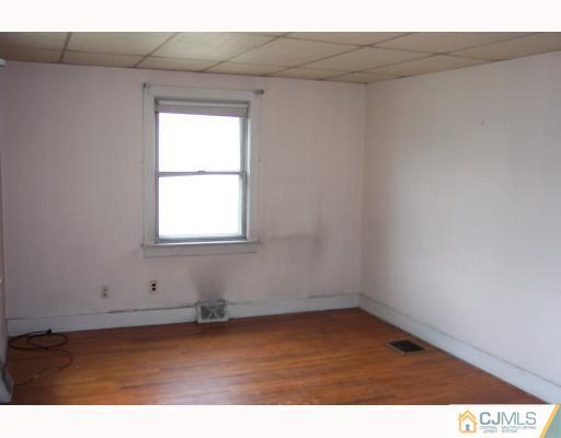 921 King Georges Post Road Edison, NJ 08837 - Photo 5 of 8 a view of an empty room with a window