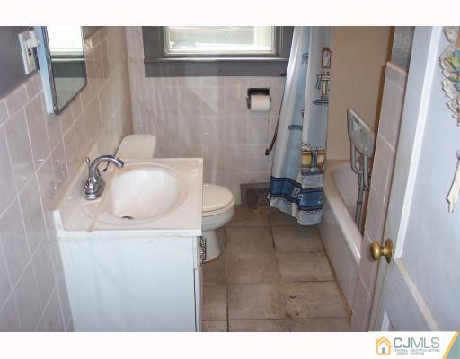 921 King Georges Post Road Edison, NJ 08837 - Photo 6 of 8 a bathroom with a sink toilet and shower