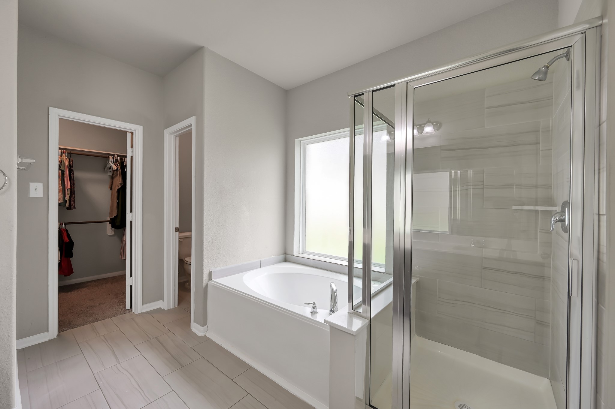 29211 Sequoia Tree Trail Spring, TX 77386 - Photo 14 of 32 a bathroom with a bathtub and a shower