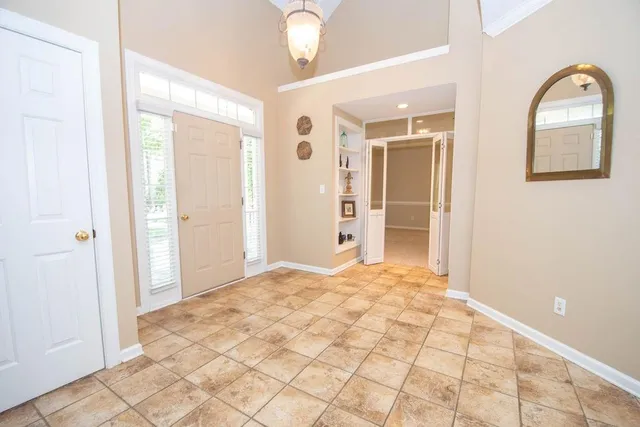 a view of an empty room with a fireplace and a window