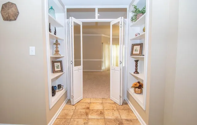 a view of a dining room with furniture a chandelier and wooden floor