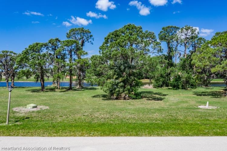 5949 Thunder Road Sebring, FL 33876 - Photo 11 of 25 a view of a grassy field with trees