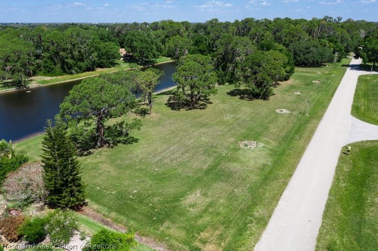 5949 Thunder Road Sebring, FL 33876 - Photo 15 of 25 a view of a lake with a yard