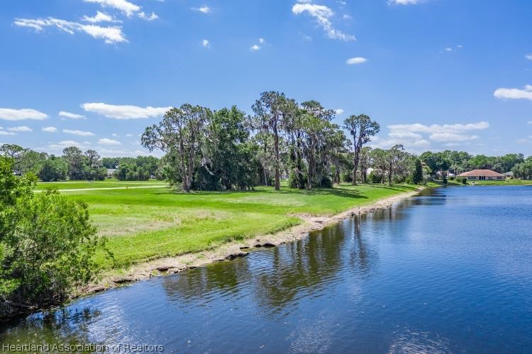 5949 Thunder Road Sebring, FL 33876 - Photo 17 of 25 a view of a lake with a yard